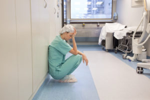 Tired Doctor in Hospital Hallway