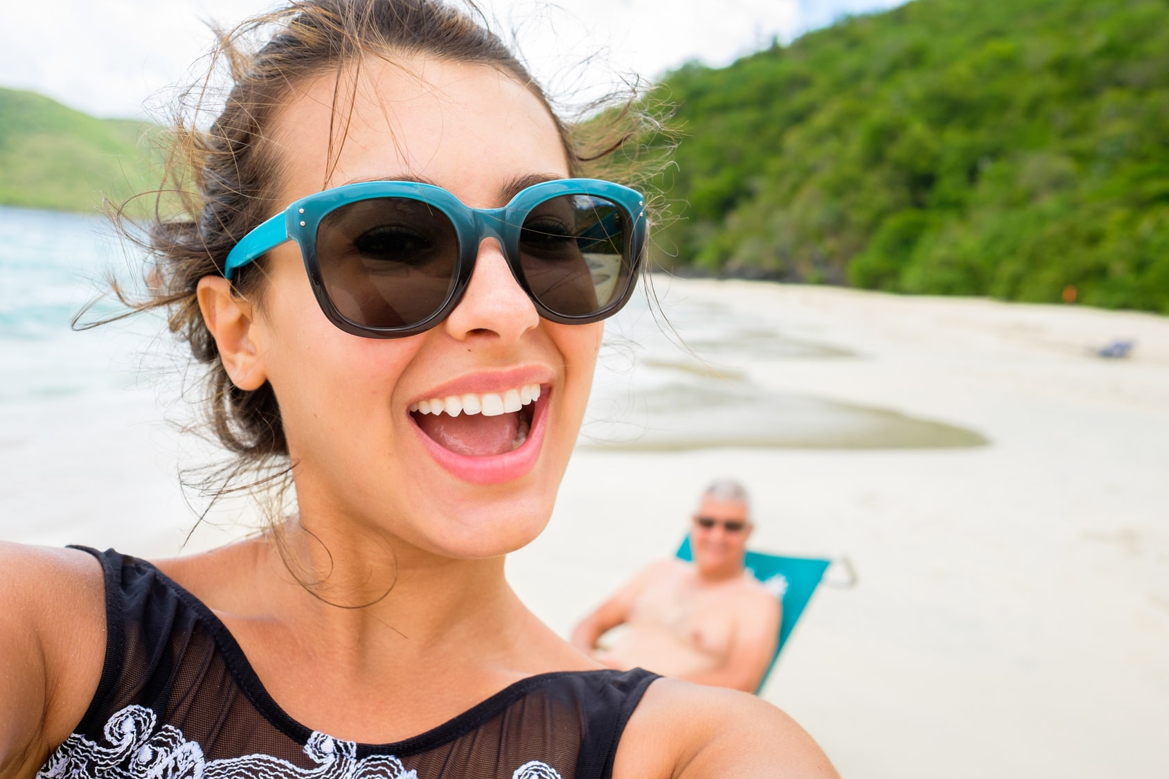 Beautiful young multicultural woman taking a selfie on a Caribbean beach.