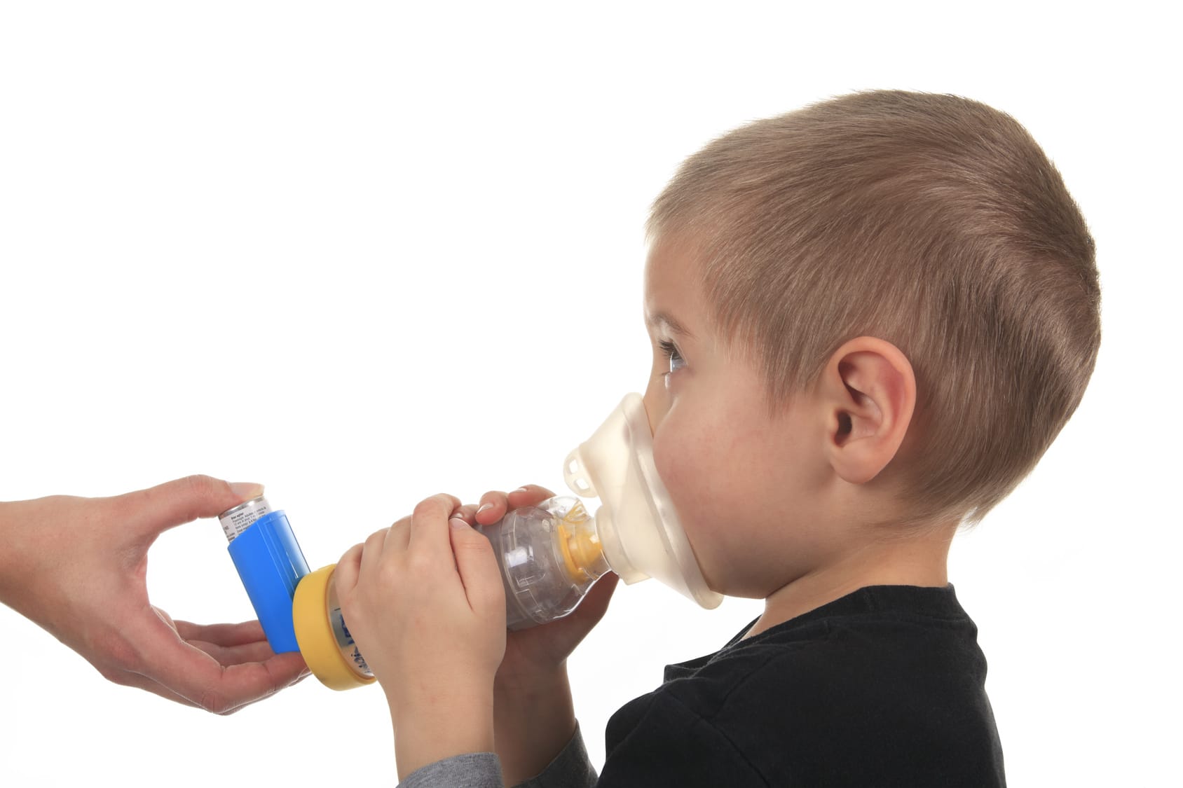 Close-up image little boy using inhaler for asthma.